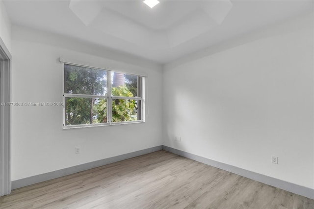 unfurnished room featuring baseboards and wood finished floors