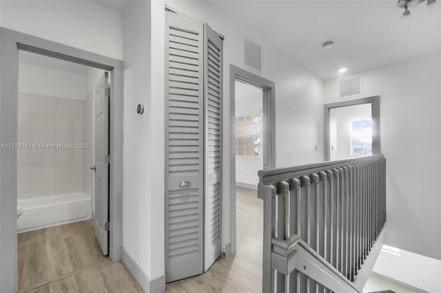 1720 NE 33rd Ave Unit 104-5, Homestead, FL 33033 - hall with plenty of natural light, light wood finished floors, and baseboards