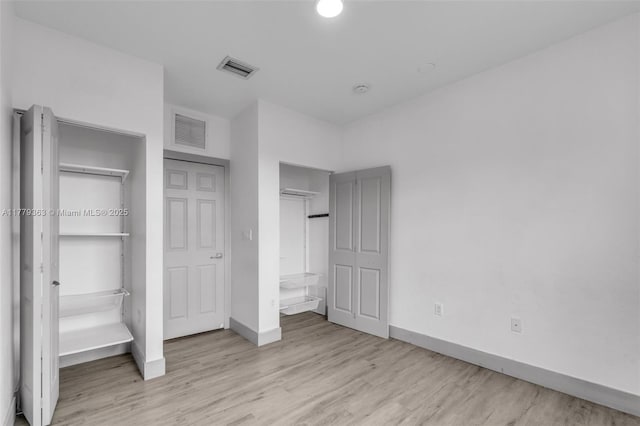 1720 NE 33rd Ave Unit 104-5, Homestead, FL 33033 - unfurnished bedroom featuring baseboards, light wood-type flooring, and a closet