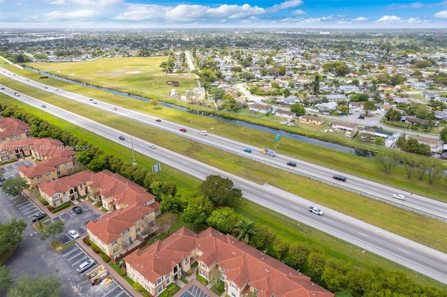 drone / aerial view with a water view and a residential view