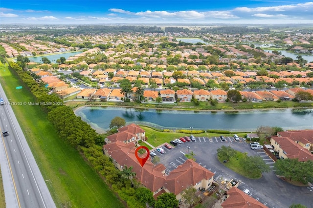 drone / aerial view with a residential view and a water view