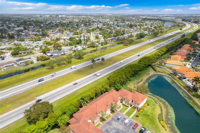 drone / aerial view with a residential view and a water view