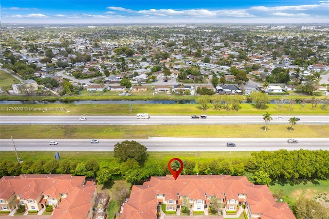 bird's eye view with a water view and a residential view