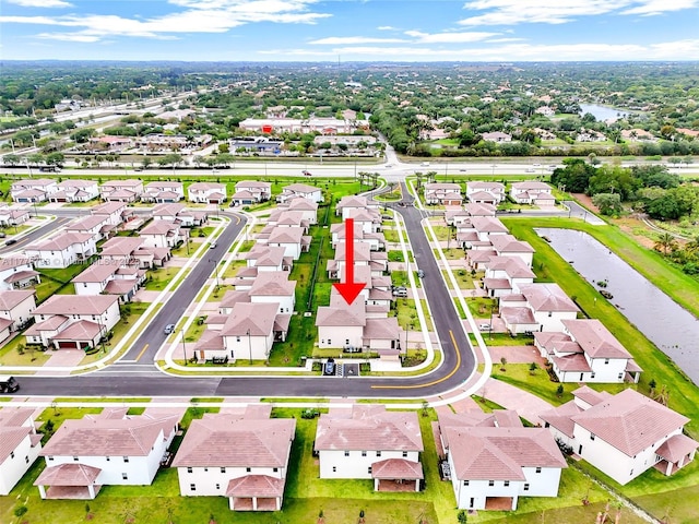bird's eye view featuring a water view and a residential view