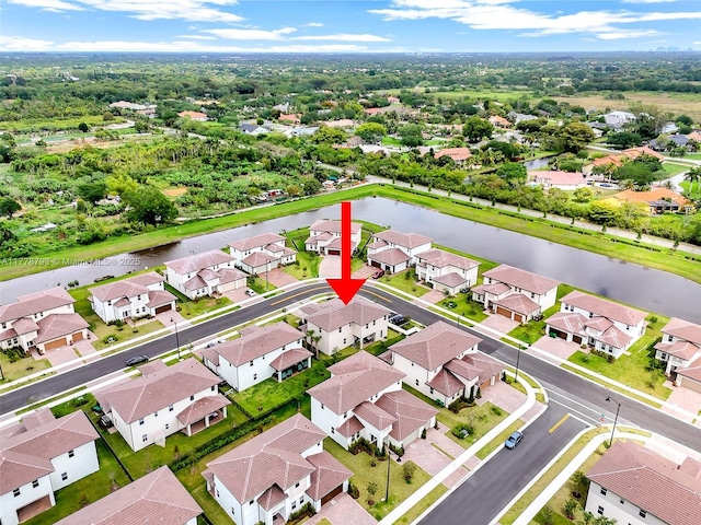 birds eye view of property with a water view and a residential view
