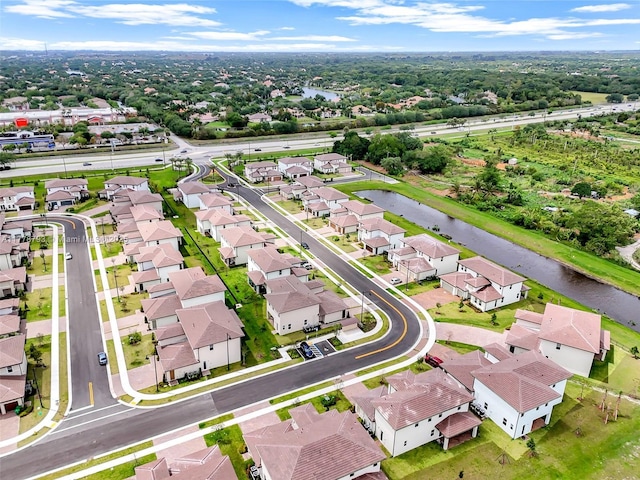 birds eye view of property featuring a residential view and a water view