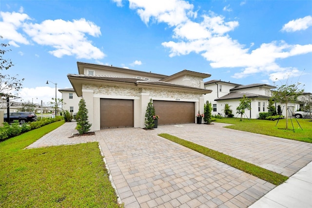 view of front of house with an attached garage, stucco siding, a front lawn, and decorative driveway