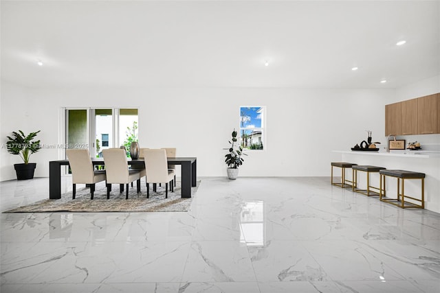 dining room featuring recessed lighting and marble finish floor