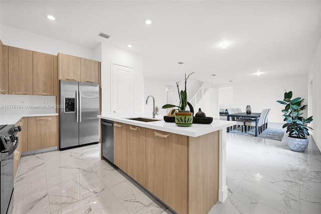 kitchen featuring visible vents, marble finish floor, a sink, and appliances with stainless steel finishes