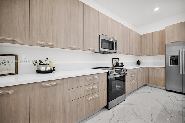 kitchen with appliances with stainless steel finishes, marble finish floor, and light countertops