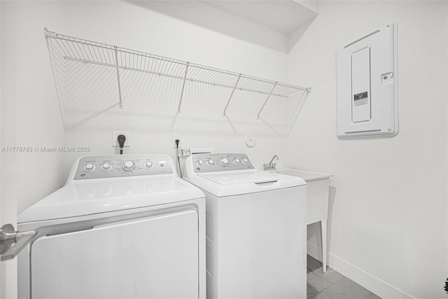 laundry area with baseboards, washer and dryer, electric panel, laundry area, and marble finish floor