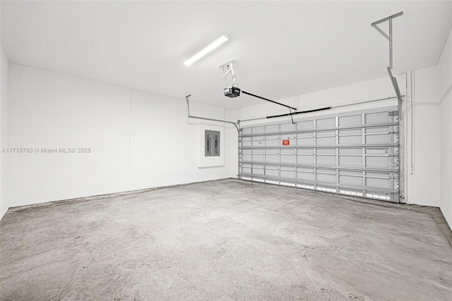 garage with a garage door opener and electric panel