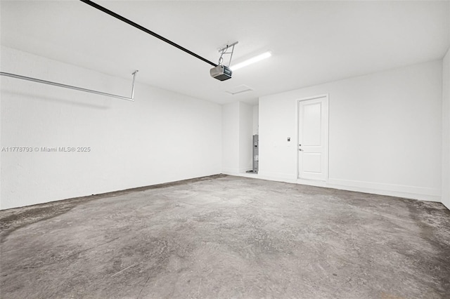 garage with water heater and a garage door opener