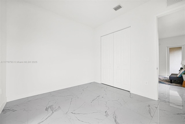 unfurnished bedroom with visible vents, marble finish floor, and baseboards