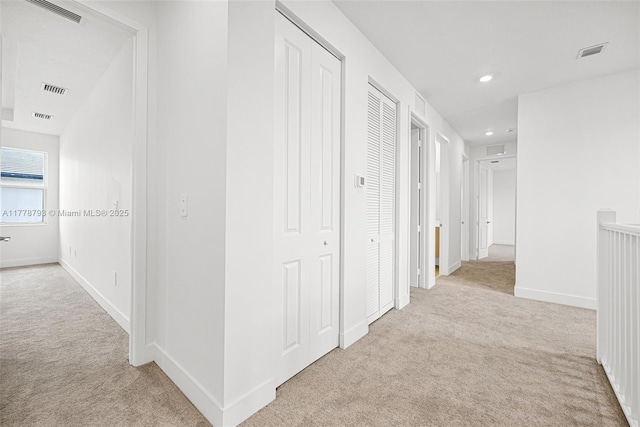 hall featuring visible vents, recessed lighting, and carpet flooring
