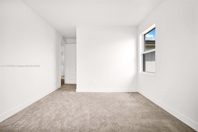 spare room with carpet flooring and baseboards