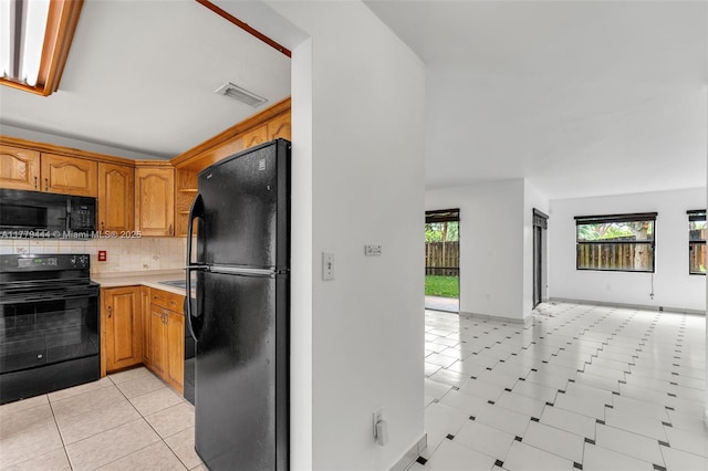 15026 SW 96th Ter, Miami, FL 33196 - kitchen with open floor plan, light countertops, backsplash, visible vents, and black appliances