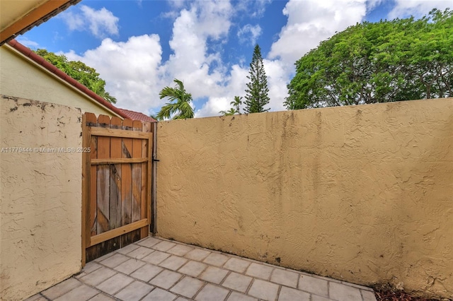 15026 SW 96th Ter, Miami, FL 33196 - view of patio / terrace featuring fence and a gate