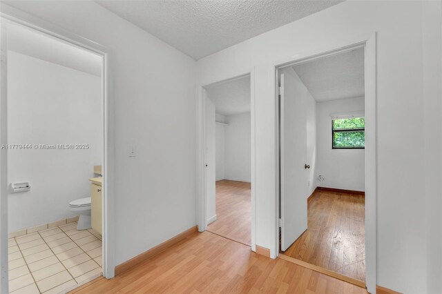 15026 SW 96th Ter, Miami, FL 33196 - interior space with baseboards, light wood-style floors, and a textured ceiling