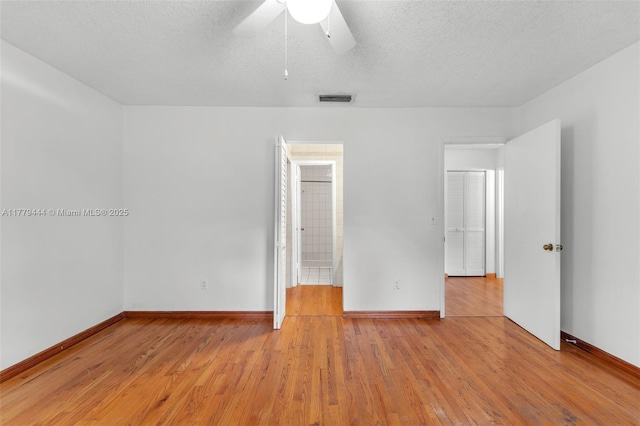 15026 SW 96th Ter, Miami, FL 33196 - unfurnished room with visible vents, light wood-type flooring, a ceiling fan, and a textured ceiling
