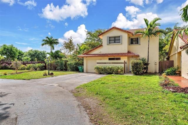 15026 SW 96th Ter, Miami, FL 33196 - mediterranean / spanish home with a front yard, a tiled roof, fence, stucco siding, and driveway