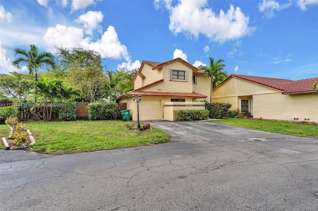 15026 SW 96th Ter, Miami, FL 33196 - mediterranean / spanish-style home featuring stucco siding, aphalt driveway, a tile roof, a garage, and fence