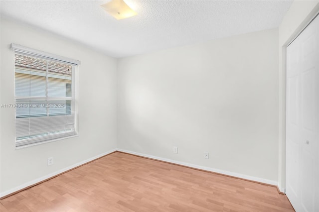 1617 Zenith Way, Weston, FL 33327 - unfurnished room with light wood-type flooring, a textured ceiling, and baseboards