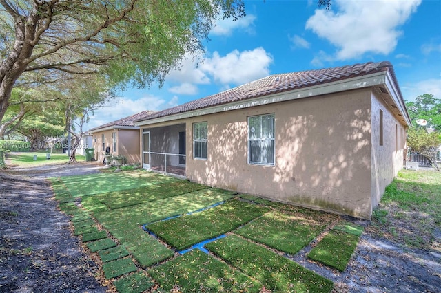 1617 Zenith Way, Weston, FL 33327 - view of property exterior featuring stucco siding, a tiled roof, and a putting area