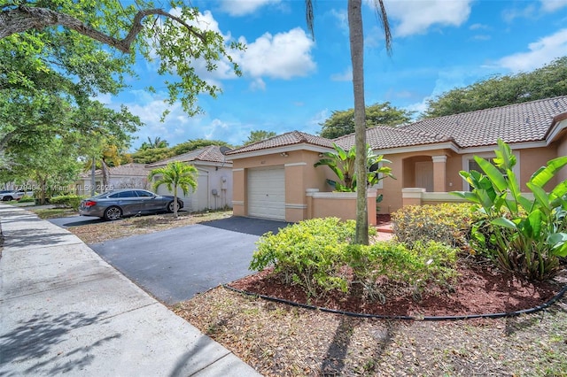 1617 Zenith Way, Weston, FL 33327 - mediterranean / spanish home featuring a tile roof, driveway, stucco siding, and an attached garage