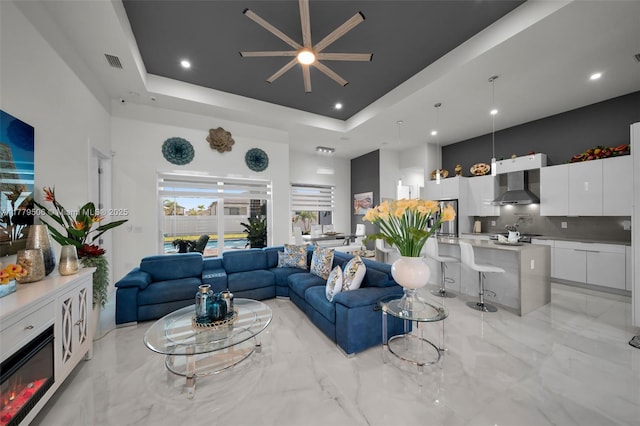 1214 Embers Pkwy, Cape Coral, FL 33993 - living room with a towering ceiling, visible vents, a ceiling fan, and a raised ceiling