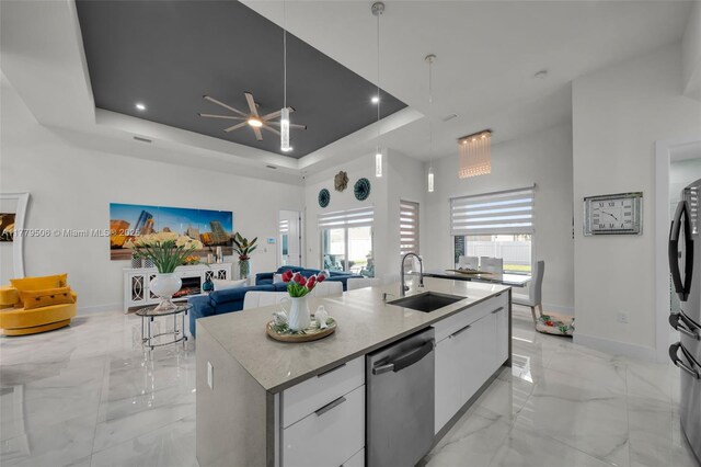 1214 Embers Pkwy, Cape Coral, FL 33993 - kitchen featuring modern cabinets, a tray ceiling, stainless steel dishwasher, marble finish floor, and a sink