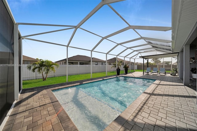 1214 Embers Pkwy, Cape Coral, FL 33993 - view of pool featuring a lawn, a fenced backyard, glass enclosure, a patio, and a fenced in pool