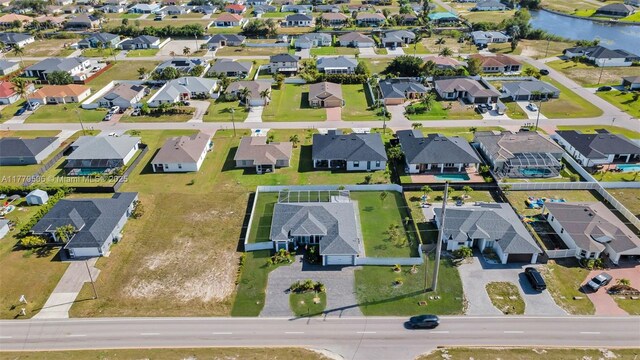 1214 Embers Pkwy, Cape Coral, FL 33993 - drone / aerial view featuring a water view and a residential view