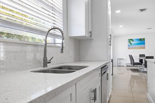 820 W Chaminade Dr, Hollywood, FL 33021 - kitchen with light tile patterned floors, white cabinetry, light stone countertops, stainless steel dishwasher, and a sink