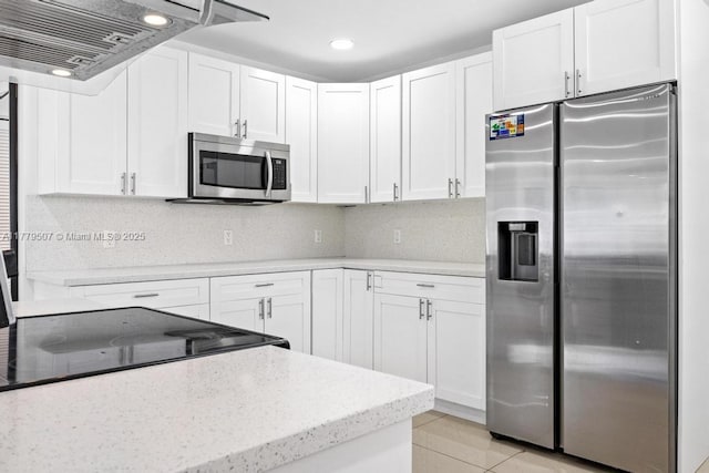 820 W Chaminade Dr, Hollywood, FL 33021 - kitchen with tasteful backsplash, white cabinetry, light stone countertops, under cabinet range hood, and appliances with stainless steel finishes