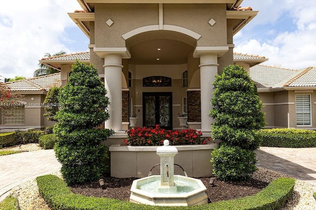 5025 Regency Isles Way, Cooper City, FL 33330 - property entrance featuring french doors, a tile roof, and stucco siding