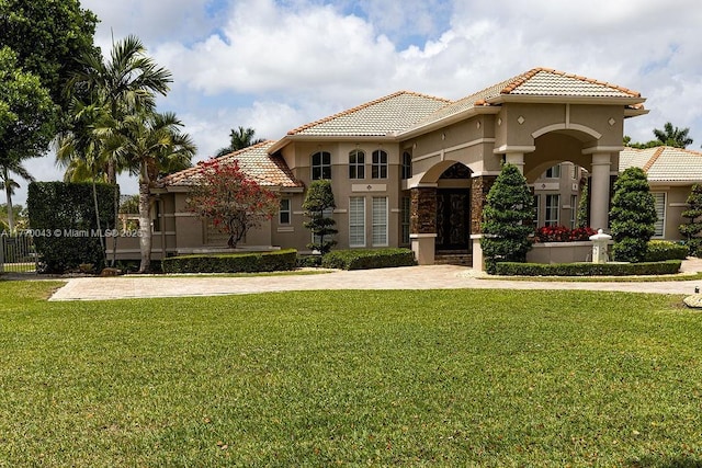 5025 Regency Isles Way, Cooper City, FL 33330 - mediterranean / spanish-style house featuring a tiled roof, a front yard, and stucco siding