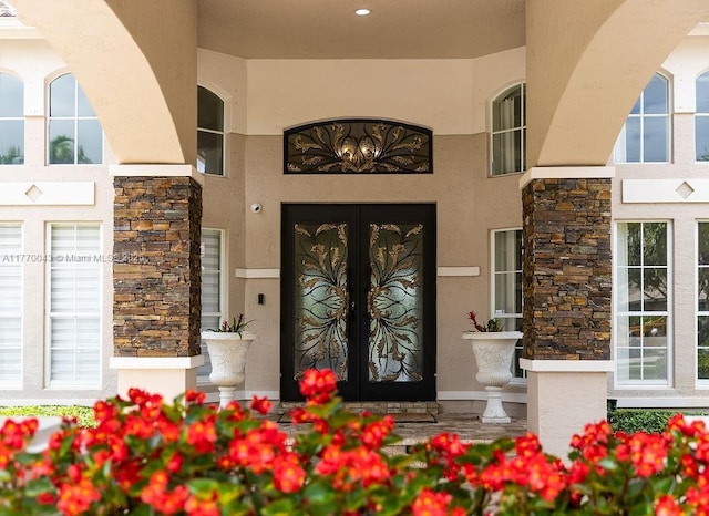 5025 Regency Isles Way, Cooper City, FL 33330 - view of exterior entry with french doors, stone siding, and stucco siding
