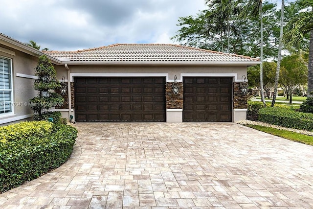 5025 Regency Isles Way, Cooper City, FL 33330 - exterior space with stucco siding, an attached garage, and decorative driveway
