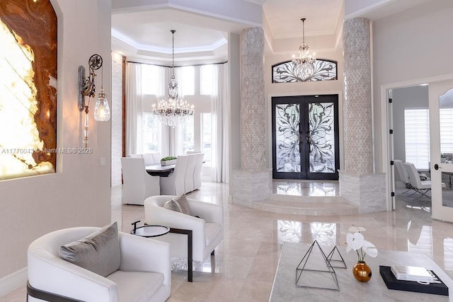5025 Regency Isles Way, Cooper City, FL 33330 - foyer entrance featuring a chandelier, french doors, a towering ceiling, a raised ceiling, and ornamental molding