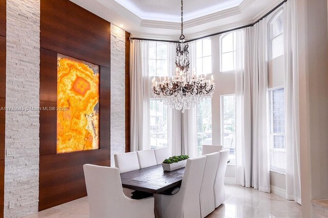 5025 Regency Isles Way, Cooper City, FL 33330 - dining room with a tray ceiling, a towering ceiling, baseboards, a chandelier, and crown molding