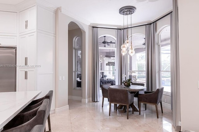 5025 Regency Isles Way, Cooper City, FL 33330 - dining area with marble finish floor, arched walkways, crown molding, and baseboards