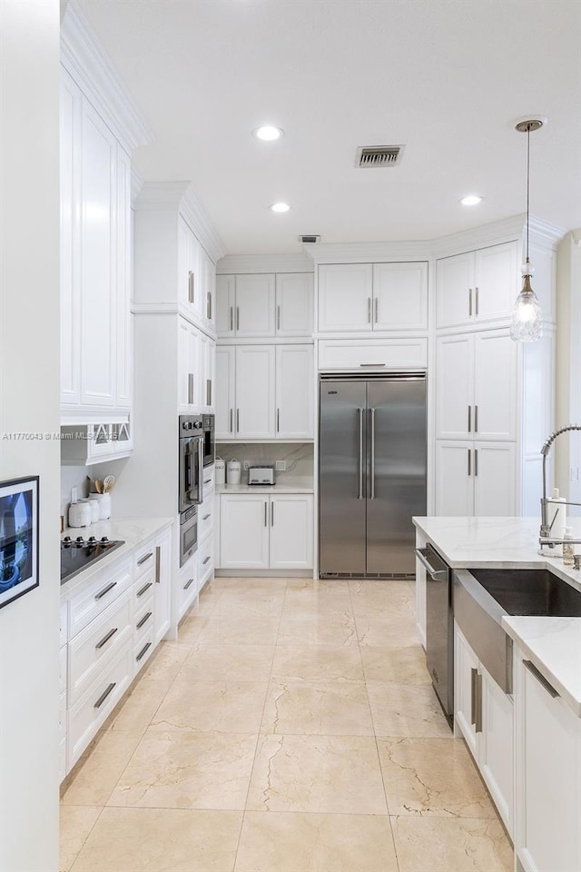 5025 Regency Isles Way, Cooper City, FL 33330 - kitchen featuring recessed lighting, stainless steel appliances, visible vents, a sink, and white cabinetry