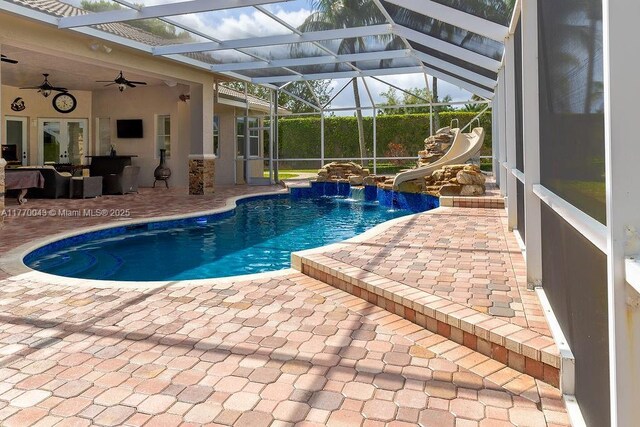 5025 Regency Isles Way, Cooper City, FL 33330 - outdoor pool featuring a patio area, a water slide, a lanai, and ceiling fan