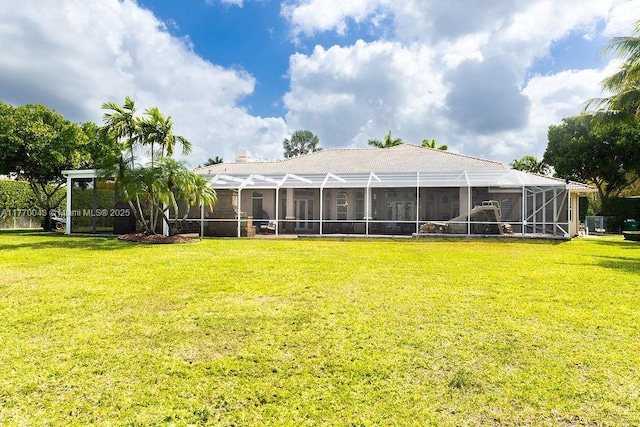 5025 Regency Isles Way, Cooper City, FL 33330 - rear view of property featuring glass enclosure and a lawn