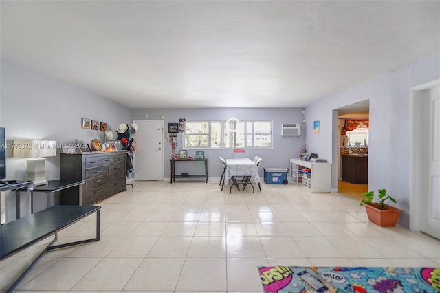 interior space featuring a wall mounted AC and light tile patterned flooring