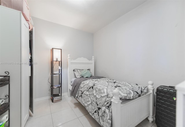 bedroom featuring baseboards and light tile patterned floors