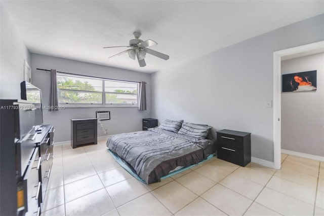 bedroom with tile patterned floors, ceiling fan, baseboards, and a wall mounted air conditioner