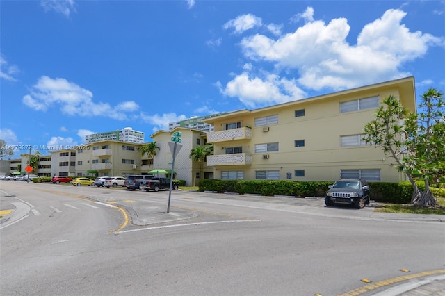 view of building exterior with uncovered parking