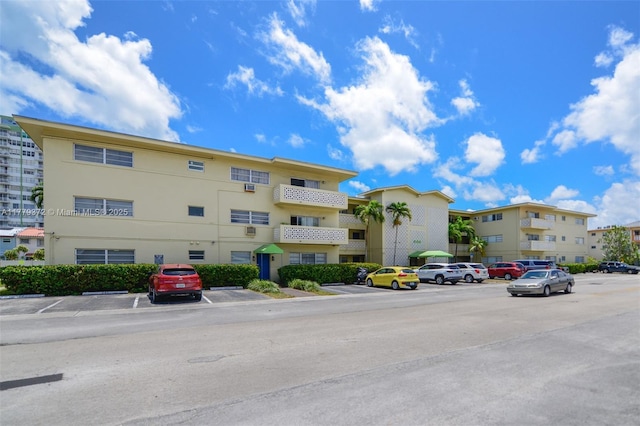view of building exterior with uncovered parking